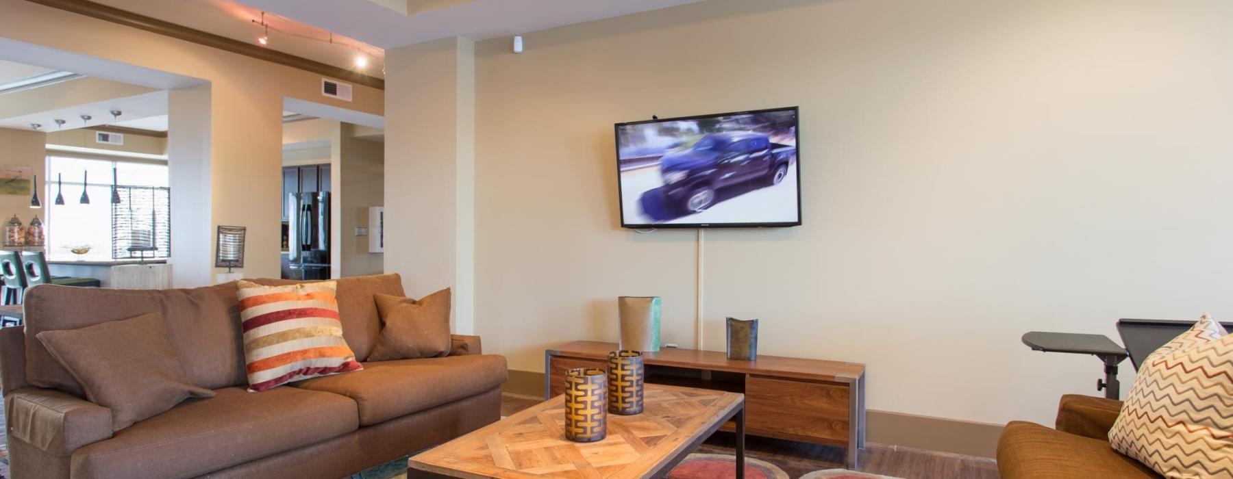 a living room with a tv and couches