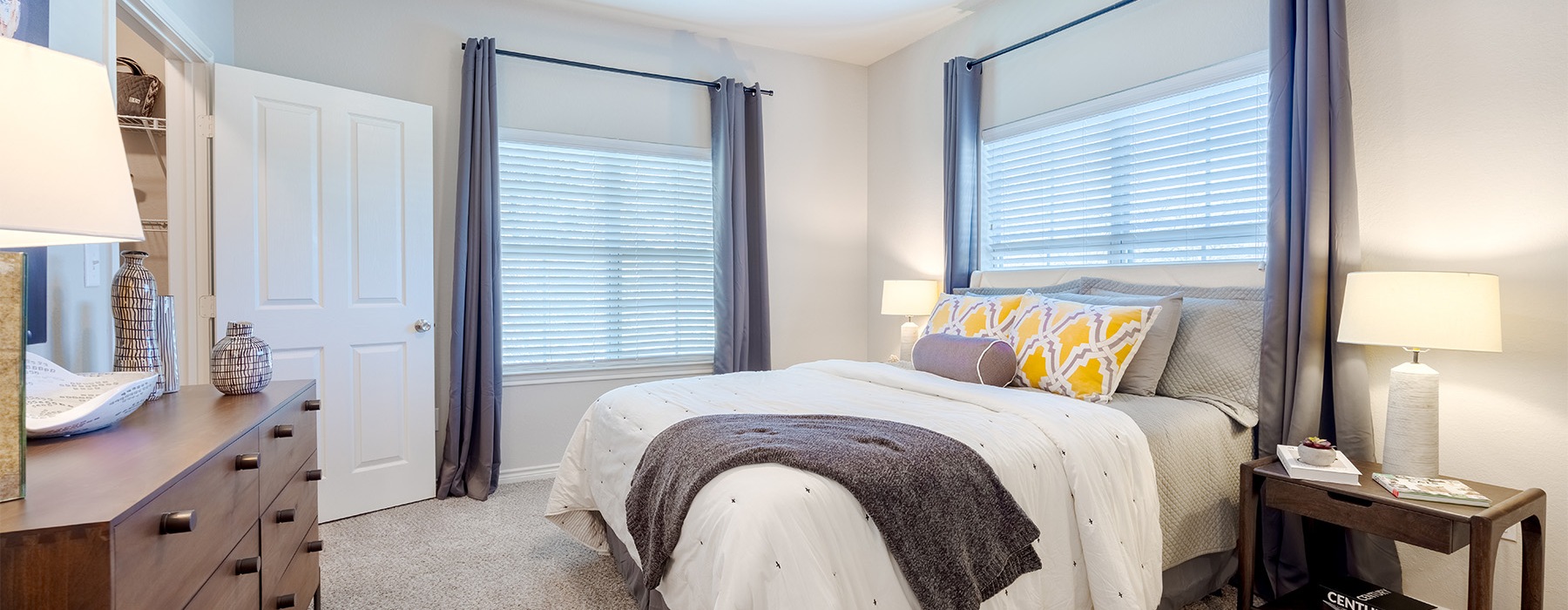 a bedroom with large windows
