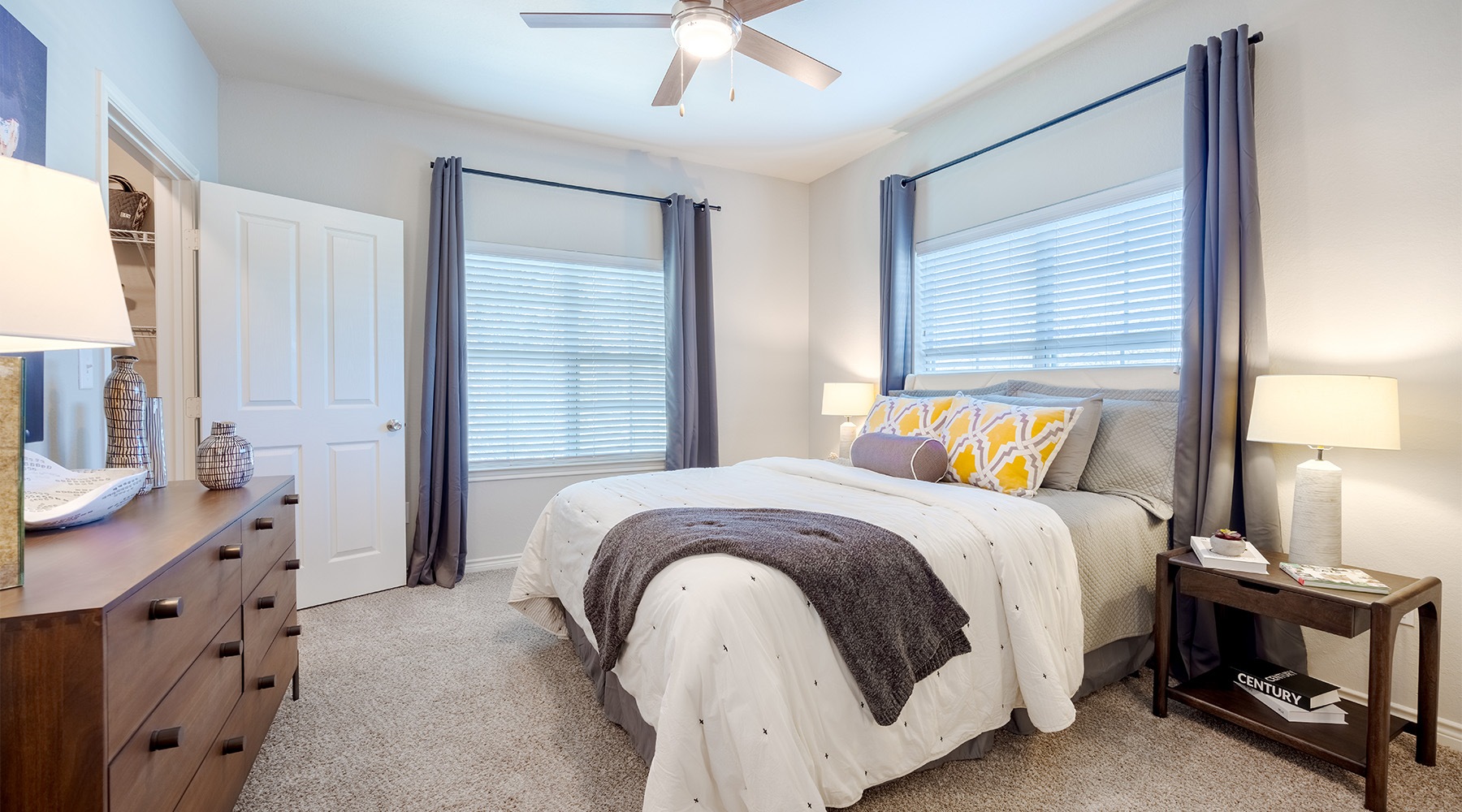 a bedroom with large windows